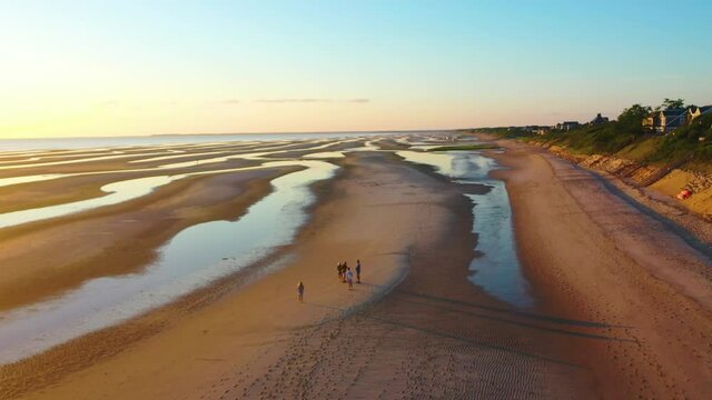 Cape Cod Bay Aerial Drone Reveal Footage of Beach at Low Tide During Golden Hour with People, Sand Bars and Puddles