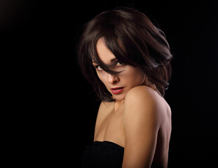Naklejka premium Alluring portrait of short bob hair style woman looking down on black background. Closeup portrait.