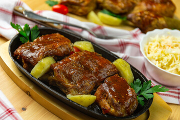 Ribs in bbq sauce with potatoes and coleslaw salad