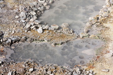 close-up of boiling hot sulfur springs with bubbles on the surface