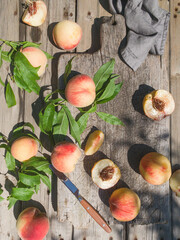 Several ripe juicy peaches on a wooden surface. Peach fruits on the wooden board. Green living. Organic food.