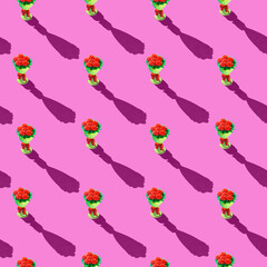 Fototapeta premium Photo seamless pattern red flowers in a yellow bouquet are arranged vertically with shadows on a colored pink background. High quality photo