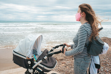 Young mom walking with her baby during covid pandemic