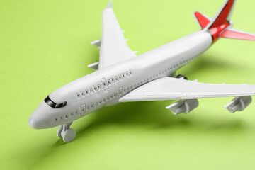 Toy airplane on green background, closeup view