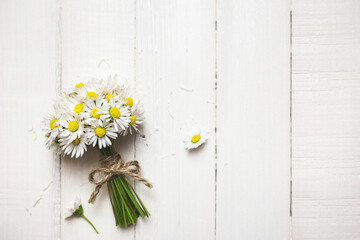 Fototapeta premium Beautiful daisy flowers on a white table
