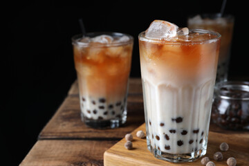 Tasty milk bubble tea on wooden table, closeup