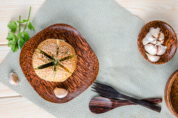 Korean Garlic Bread on Wood plate with Garlic Wood Background
