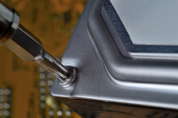 disassembling a computer hard drive using a screwdriver to diagnose and repair problems.