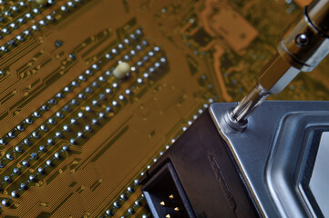 disassembling a computer hard drive using a screwdriver to diagnose and repair problems.