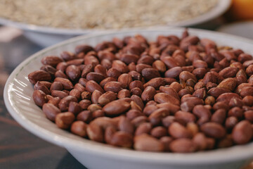 Roasted peanuts in a plate. Close-up. Macro shot. Selective focus.