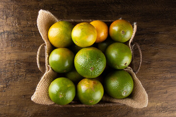 Orange fruit in the basket. Tropical fruits. Top view.