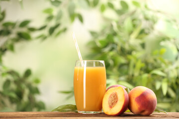 Fototapeta premium Natural peach juice and fresh fruits on wooden table. Space for text