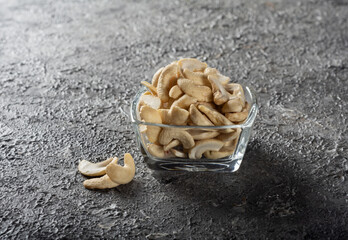 Cashew nuts in a square glass bowl on the table