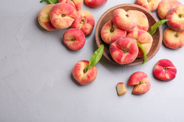 Fresh ripe donut peaches on light table, flat lay. Space for text
