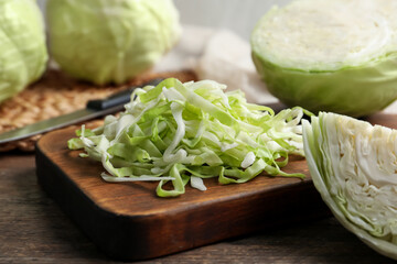 Fresh shredded cabbage on wooden table, closeup