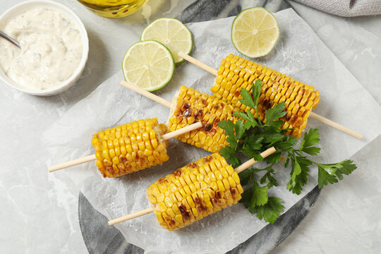 Flat lay composition with tasty grilled corn on table