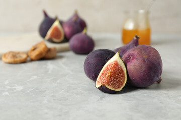 Tasty raw figs on light grey marble table, closeup