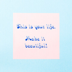 Motivational quote this is your life, make it beautiful! Lettering on a pink sticker in calligraphic letters.