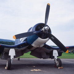 Parked corsair with its inverted gull wing and its huge three-bladed propeller