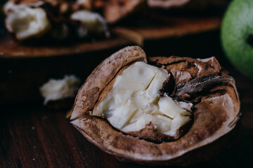 Half of walnut.Close-up on rustic old table. Macro shot.
