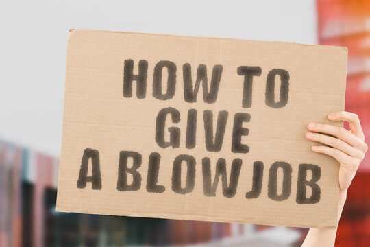 Hand holding cardboard sign with text "how to give a blow job"