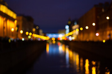 Fototapeta na wymiar Blurred abstract bokeh background of Saint Petersburg golden lights on Griboyedov Canal at night