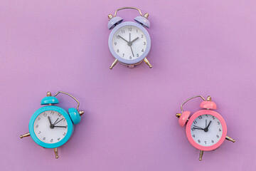 Simply minimal design three ringing twin bell classic alarm clock Isolated on purple violet...