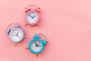 Simply minimal design three ringing twin bell classic alarm clock Isolated on pink pastel background. Rest hours time of life good morning night wake up awake concept. Flat lay top view copy space.
