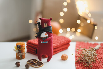 Autumn cozy still life with toy, sweaters and leaves. sweater-weather. Creative autumn backdrop concept. Flat lay, hygge style