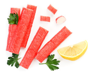 Crab sticks, parsley and lemon slice on a white background, isolated. Top view