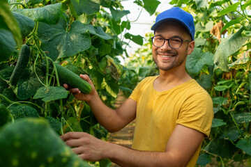 Portrait of smiling farmer in greenhouse