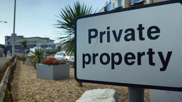 Private property sign enter forbidden in a small garden Newhaven harbor - 4k video