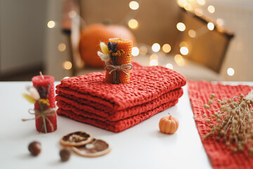 Cozy autumn hygge composition. still life with candle, leaves, pumpkin, textiles. Halloween, Thanksgiving. Flat lay, top view