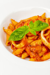 Pasta with seafood and tomato sauce close up