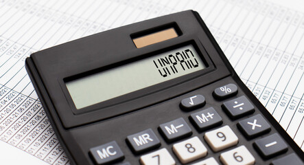 A calculator with the word UNPAID on the display