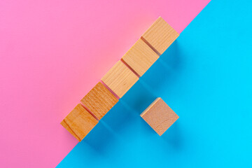 Top view photo of wooden blocks on pink and blue