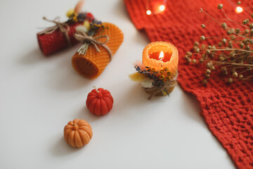 Cozy autumn hygge composition. still life with candle, leaves, pumpkin, textiles. Halloween, Thanksgiving. Flat lay, top view