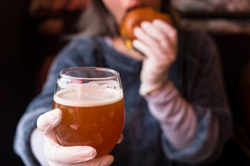 Girl with glass of beer and burger