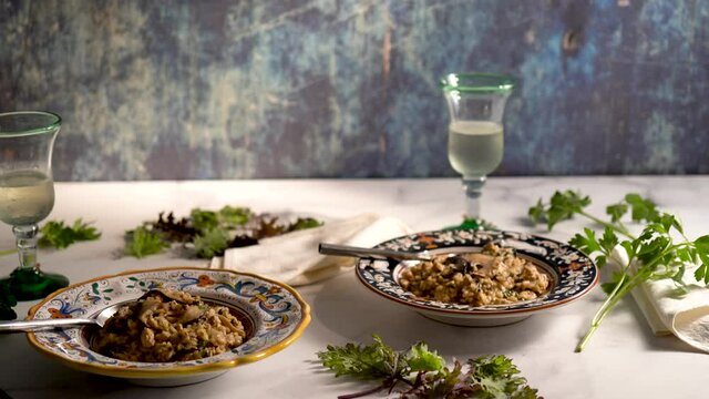 Slider to right of Italian bowls of shiitake kale risotto with prosecco wine.