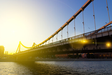 Krymsky Bridge or Crimean Bridge is illuminated by the bright rays of the sun in Moscow city, Russia