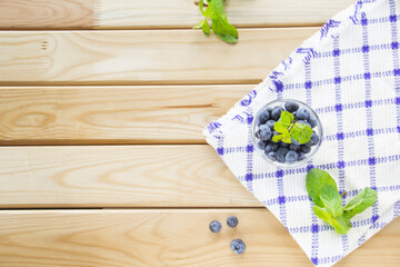  Juicy and fresh blueberries with green leaves. Creative atmospheric decoration