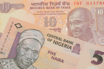 A macro image of a orange ten rupee bill from India paired up with a orange, plastic five naira note from Nigeria.  Shot close up in macro.