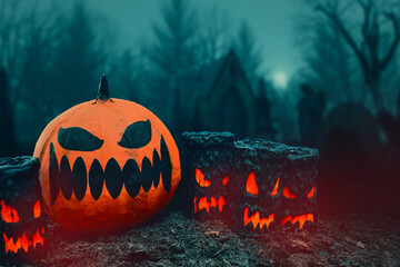 Pumpkin and candles in cemetery