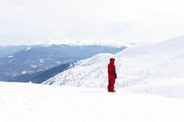 winter, leisure, sport and people concept - Snowboarder stands on backcountry slope and holds snowboard. Ski concept