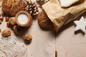christmas decoration in rustic style and holiday background, still life on wooden backdrop, bread, nuts and other