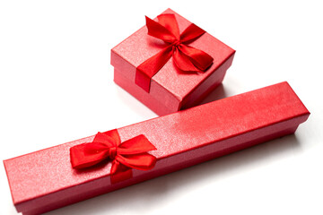 Two red boxes for jewelry with red ribbons for any holiday isolated items on a white background top view