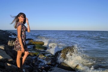 Girl on the rocks by the sea
