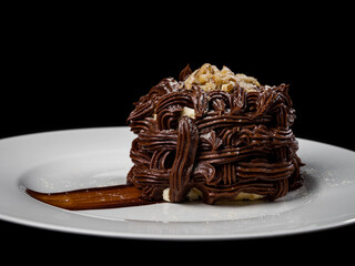 Kiev cake with nuts and chocolate. Close-up photography in a restaurant. Sweet delicious dessert of Russian cuisine.