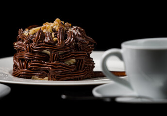 Kiev cake with nuts and chocolate. Close-up photography in a restaurant. Sweet delicious dessert of Russian cuisine.