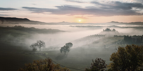 Autumn fog in valley on sunrise